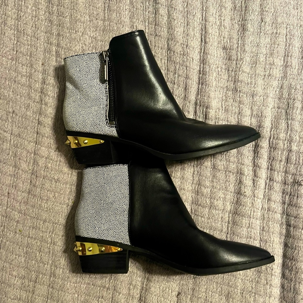 Black bootie with pattern heel and gold spike heel. 1.5 inch heel. Like new.